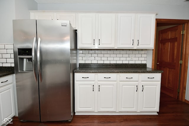 kitchen with stainless steel fridge, decorative backsplash, dark hardwood / wood-style floors, and white cabinets