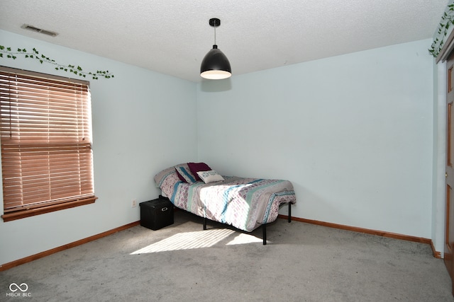 carpeted bedroom with a textured ceiling