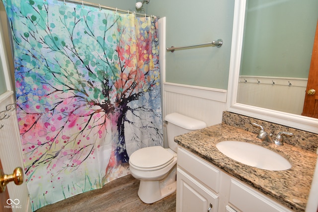 bathroom with vanity, hardwood / wood-style floors, toilet, and walk in shower