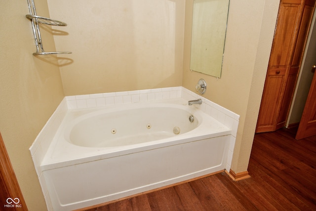 bathroom featuring a tub and hardwood / wood-style floors