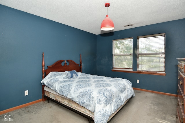 carpeted bedroom with a textured ceiling