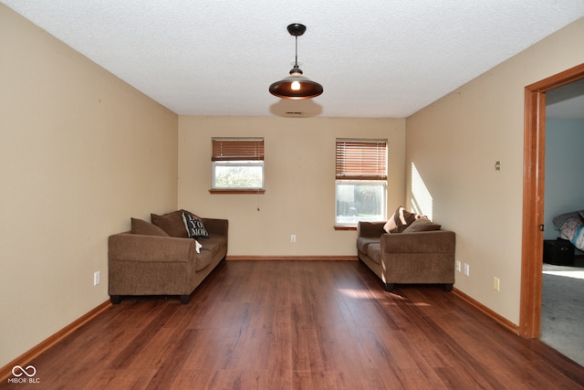 unfurnished room featuring a textured ceiling and dark hardwood / wood-style flooring