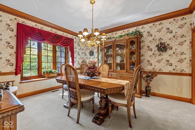 carpeted dining area with crown molding and a notable chandelier