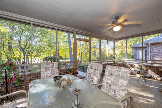 sunroom / solarium featuring ceiling fan