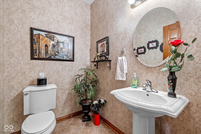 bathroom with toilet and tile patterned flooring