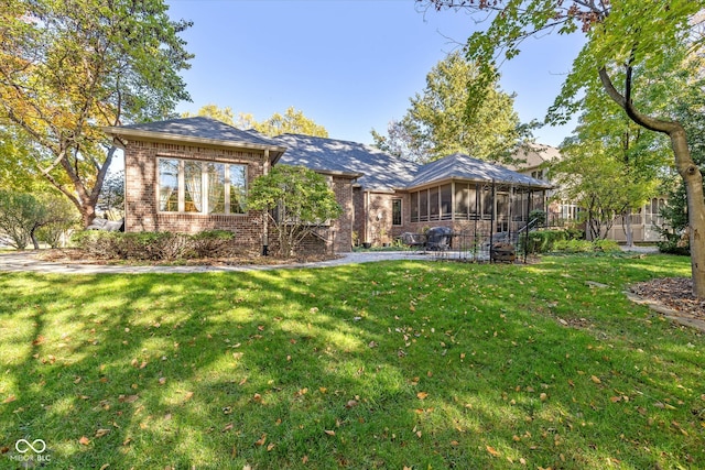 view of front of house featuring a front yard and a sunroom