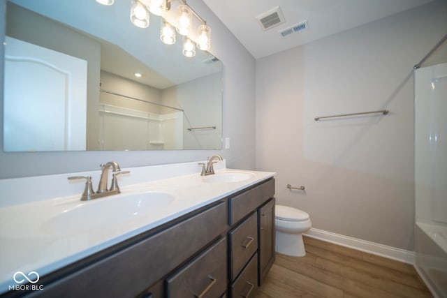 bathroom featuring hardwood / wood-style floors, vanity, and toilet