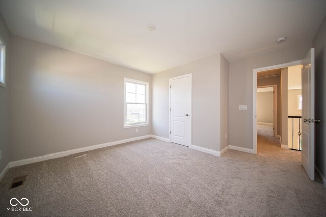 unfurnished bedroom featuring light colored carpet