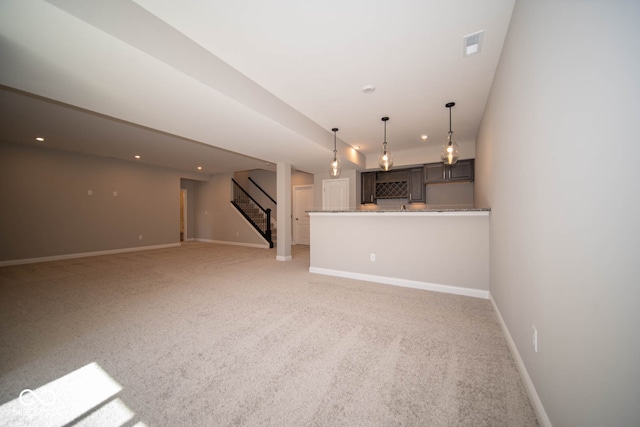 unfurnished living room featuring light carpet