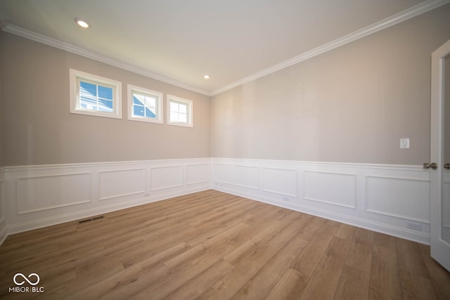 unfurnished room with hardwood / wood-style flooring and crown molding