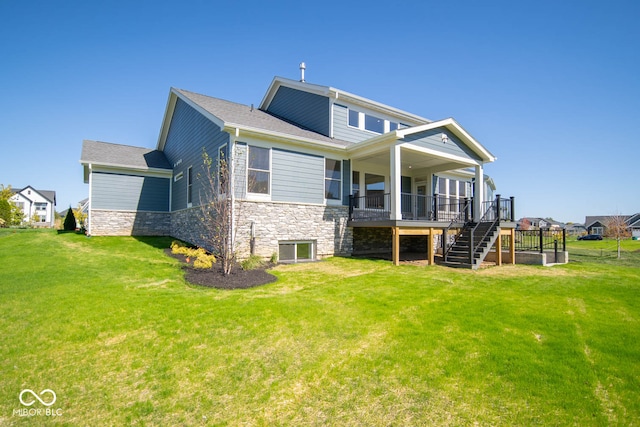 rear view of property with a lawn and a deck