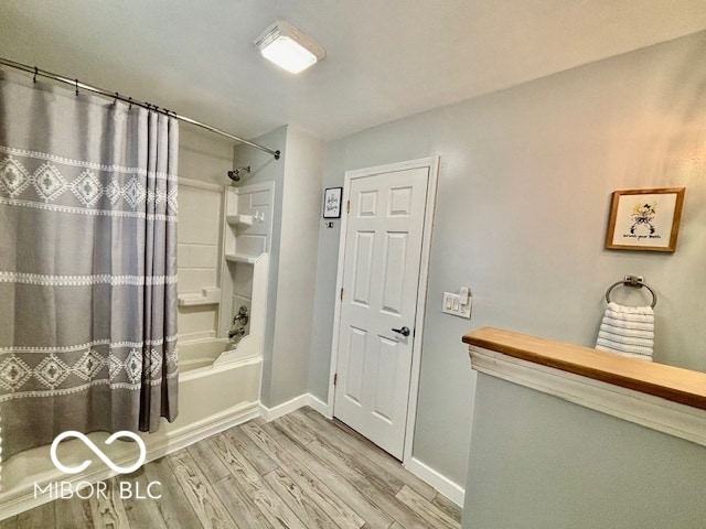 bathroom featuring wood-type flooring and shower / bath combo