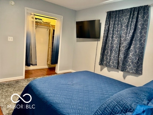 bedroom with a closet and dark hardwood / wood-style floors