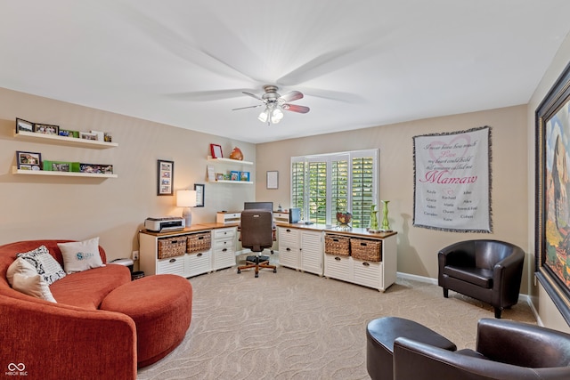 office area with ceiling fan, baseboards, and light carpet