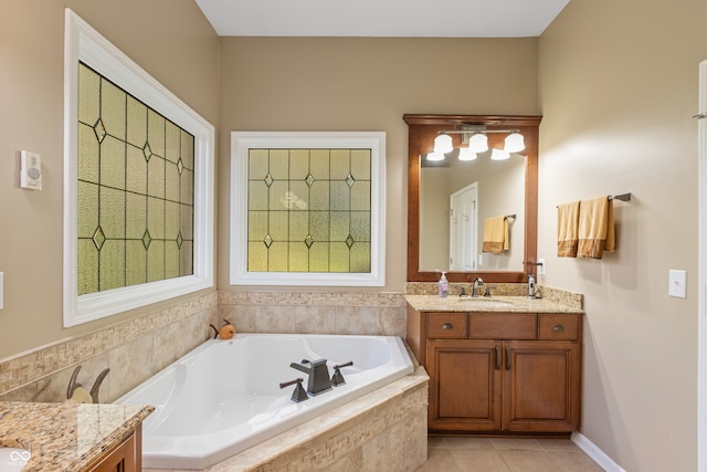 bathroom featuring vanity, tiled bath, and tile patterned floors