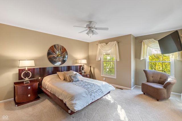 bedroom featuring light colored carpet and ceiling fan