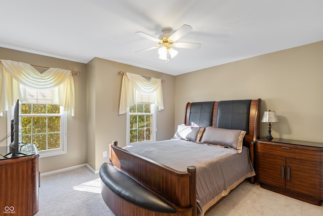 bedroom featuring a ceiling fan, baseboards, and light carpet
