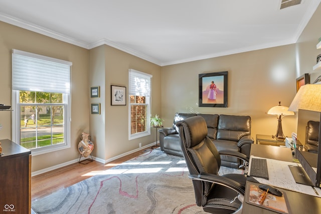 office area with baseboards, wood finished floors, visible vents, and crown molding