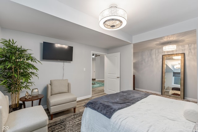 bedroom featuring wood finished floors and baseboards