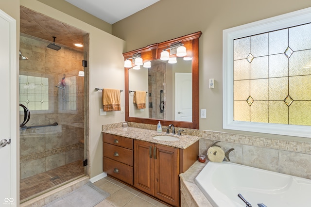 bathroom featuring vanity, independent shower and bath, and tile patterned flooring