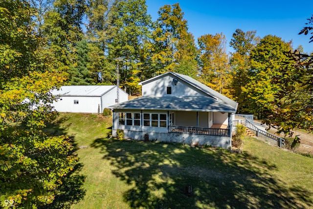 rear view of property with a lawn