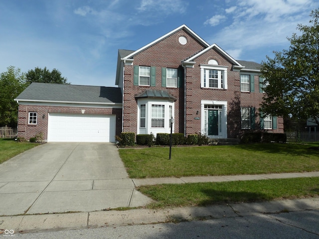 colonial house featuring a garage and a front lawn