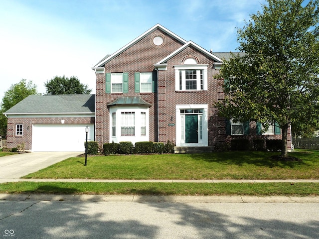 view of front of property featuring a front yard and a garage