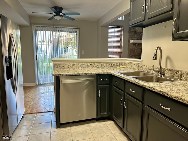 kitchen featuring ceiling fan, sink, stainless steel appliances, kitchen peninsula, and light wood-type flooring