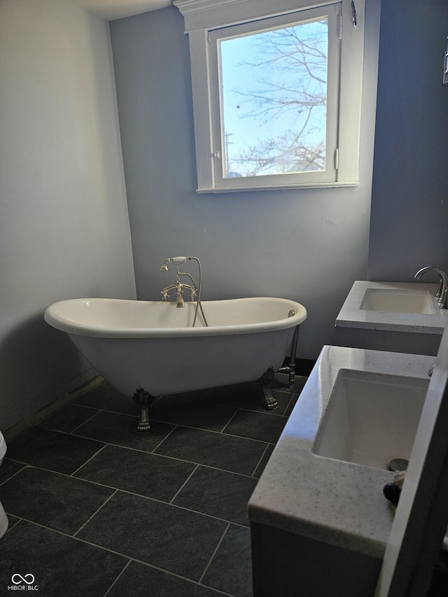 201 W Walnut St, Waldron, IN 46182 - bathroom featuring a freestanding tub, double vanity, and tile patterned floors