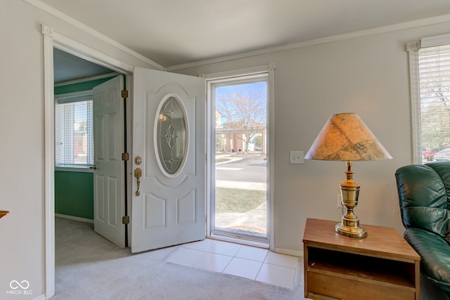 carpeted entrance foyer with crown molding