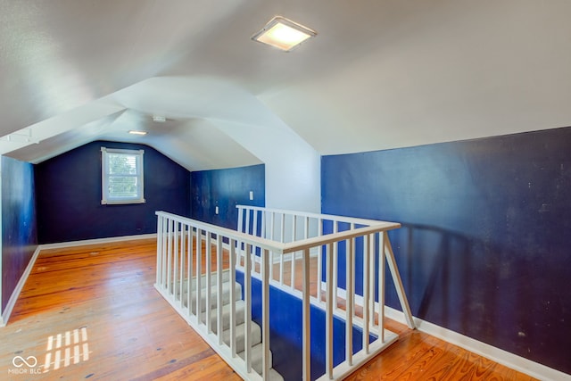 interior space with wood-type flooring and vaulted ceiling