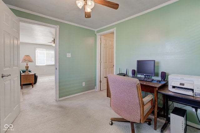 carpeted home office featuring ceiling fan and crown molding