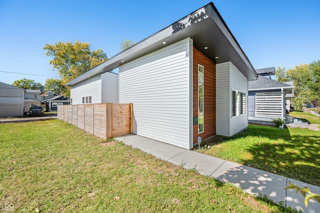 view of side of property with a yard