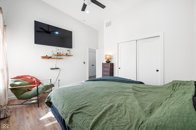 bedroom featuring a closet, ceiling fan, high vaulted ceiling, and hardwood / wood-style floors