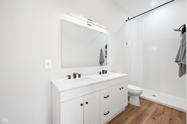 bathroom with vanity, hardwood / wood-style flooring, toilet, and walk in shower