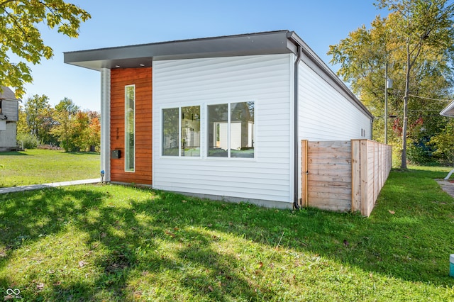 view of property exterior featuring a lawn