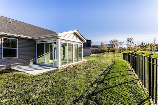 view of yard with a sunroom and a patio area