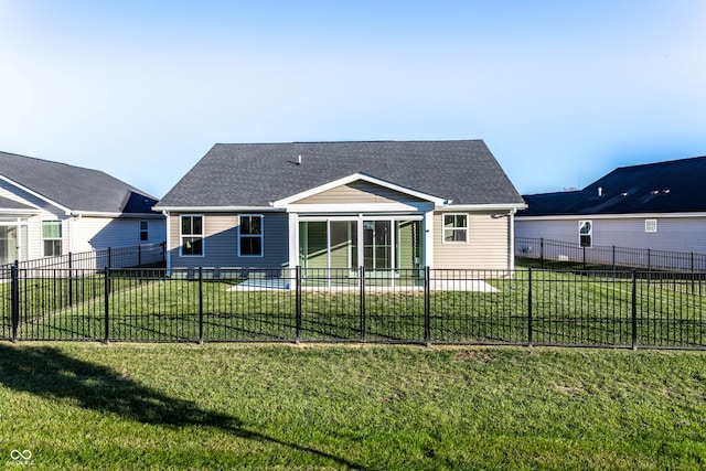 rear view of house with a lawn