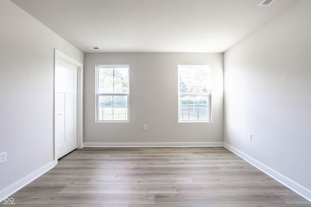 unfurnished room with light hardwood / wood-style floors