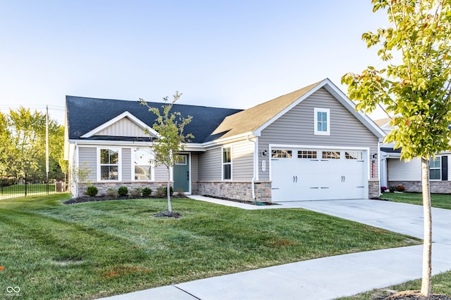 view of front of property with a garage and a front lawn