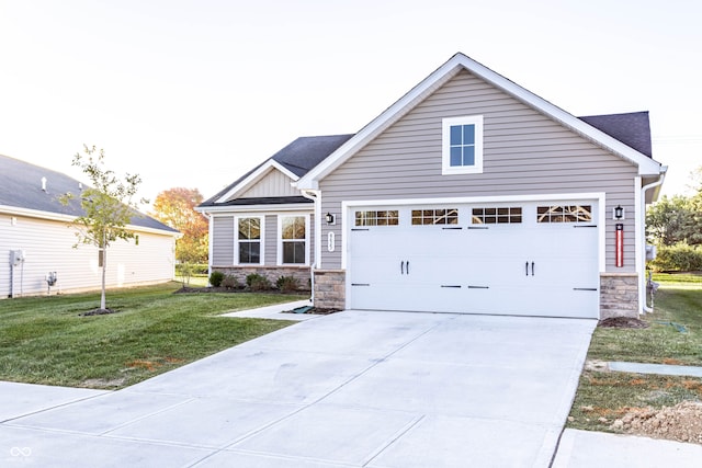 view of front of property with a front yard and a garage