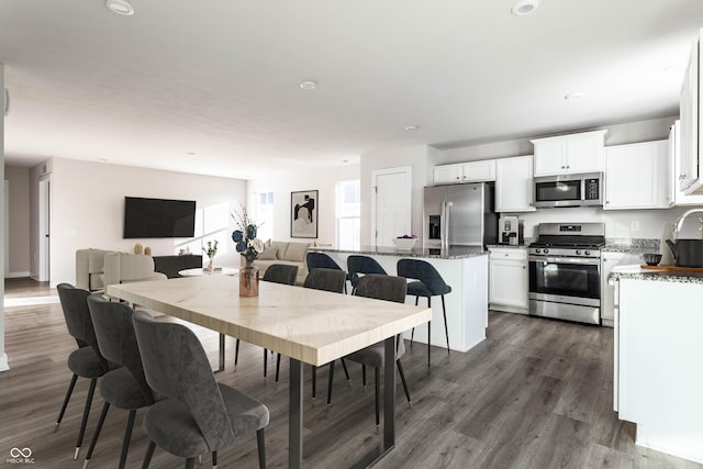 dining space with dark hardwood / wood-style floors