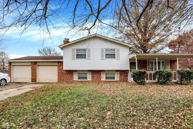 split level home with a garage and a front lawn