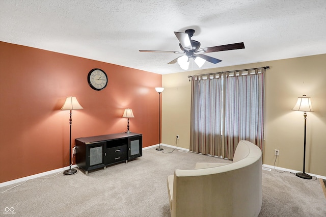 sitting room featuring ceiling fan, a textured ceiling, and carpet floors