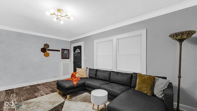 living room with hardwood / wood-style flooring, a notable chandelier, and ornamental molding