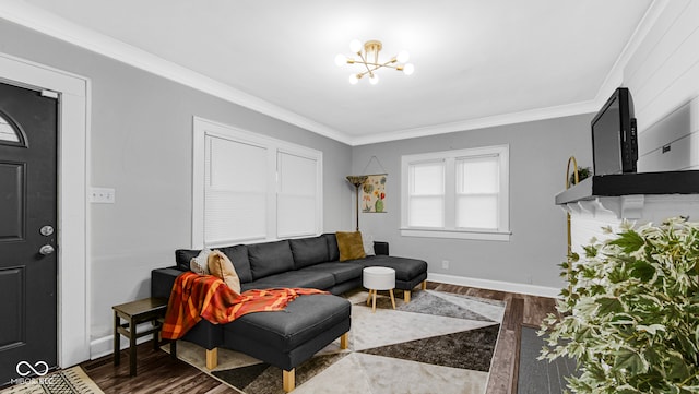 living room with hardwood / wood-style floors, crown molding, and a notable chandelier