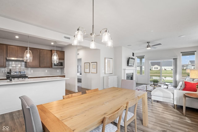 802 Weldon Way, Westfield, IN 46074 - dining space with ceiling fan, wood finished floors, recessed lighting, and a fireplace