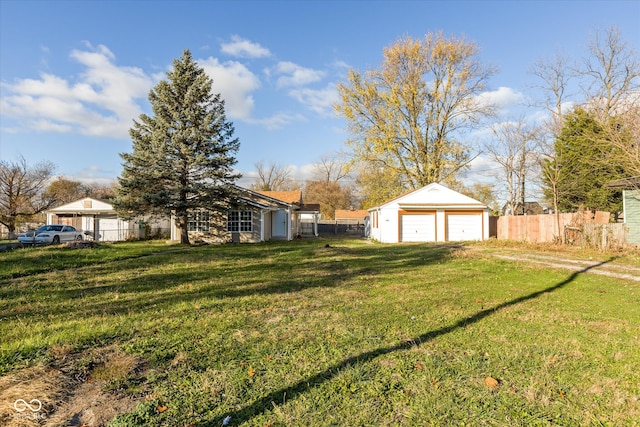 view of yard with a garage and an outdoor structure