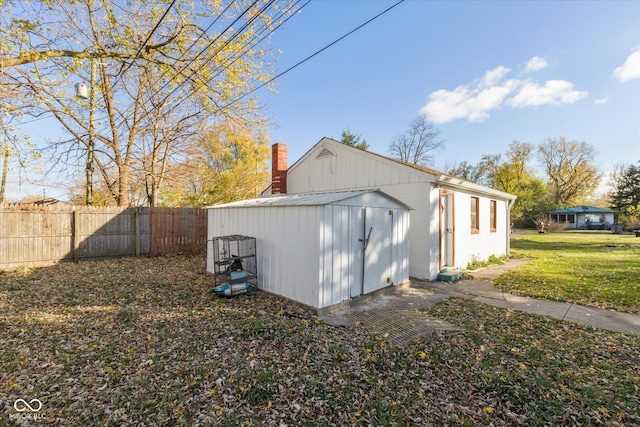 view of side of home featuring a storage unit