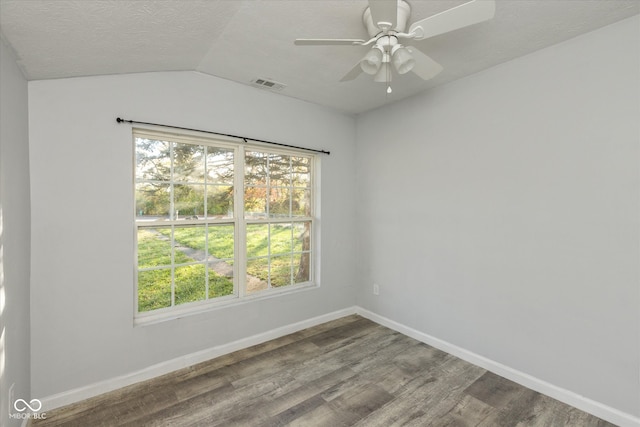 unfurnished room with hardwood / wood-style flooring, ceiling fan, lofted ceiling, and a textured ceiling